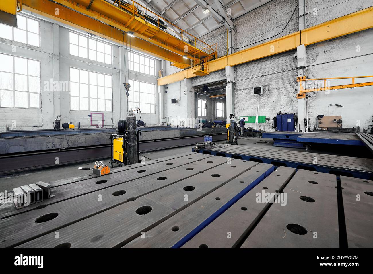 Long steel constructions assembling with welding in workshop Stock Photo
