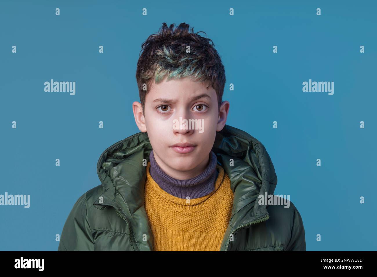 Serious and playful studio portrait of a tenyearold Caucasian boy
