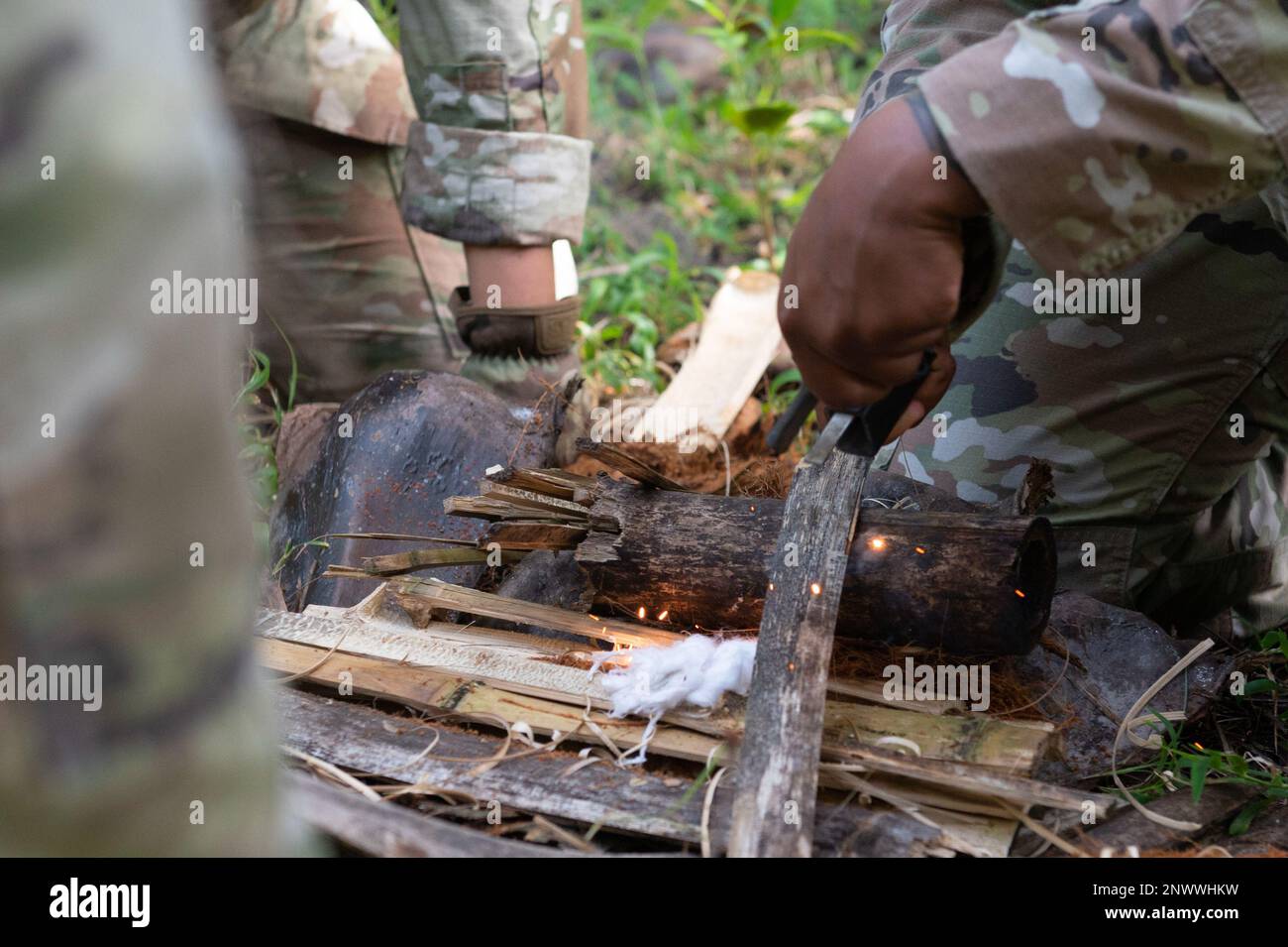 Members of the U.S. Air Force attempt to light a fire during Pacific