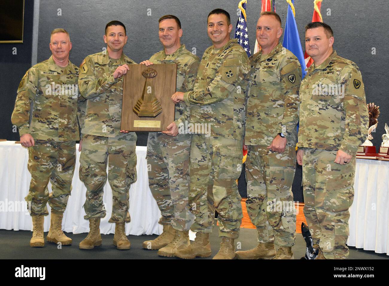 The 404th Aviation Support Battalion, Fort Carson, Colorado, is awarded the 2022 Lt. Gen. Ellis D. Parker Award, Combat Service and Support category, during the Aviation Senior Leader Forum Jan. 25, 2023, at Fort Rucker, Ala.  Receiving the award on the unit's behalf is Col. Ruisanchez, Chief Warrant Officer 5 Kearns, and Command Sgt. Maj. Gamez, 4th Combat Aviation Brigade. The award was presented by Maj. Gen. Michael McCurry, U.S. Army Aviation Center of Excellence commander and Army aviation branch chief, Chief Warrant Officer 5 Myke Lewis, chief warrant officer of the branch, and Command S Stock Photo