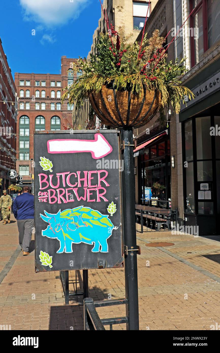 A sign directs pedestrians to the Butcher and the Brewer restaurant on East 4th in the downtown Cleveland, Ohio Gateway District on February 15, 2023. Stock Photo