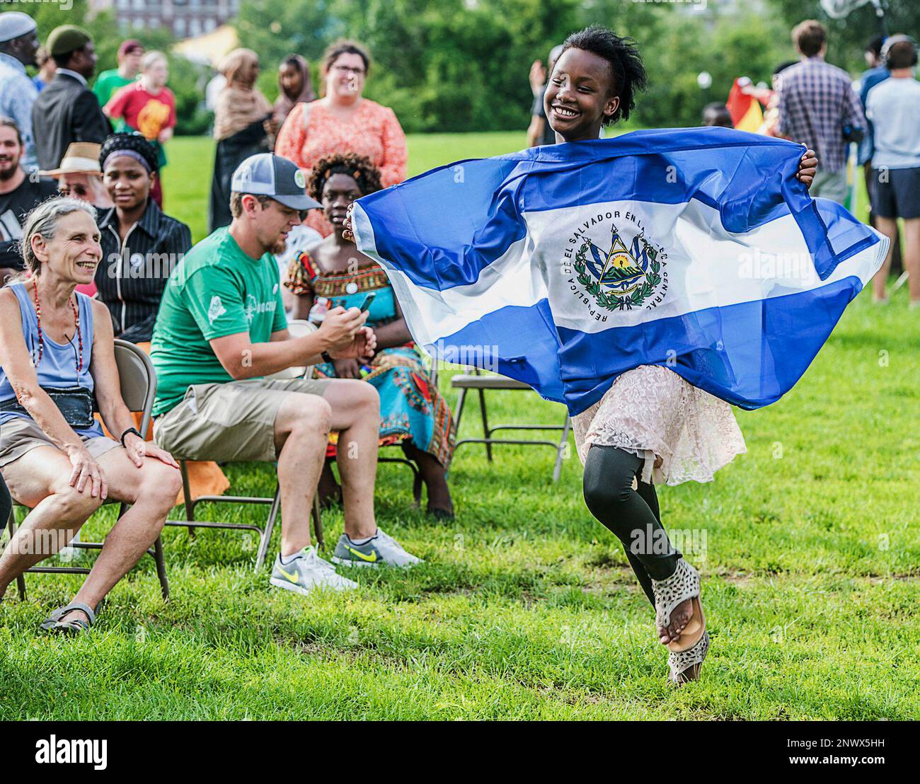 A participant of World Refugee Day runs to the stage with the El