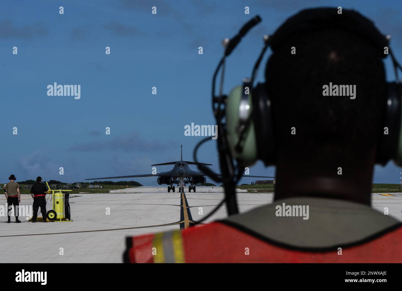 U.S. Airmen from the 34th Expeditionary Bomb Squadron prepare to marshal a B-1B Lancer at Andersen Air Force Base, Guam, in support of a Bomber Task Force deployment, Feb. 4, 2023. The BTF missions demonstrate lethality and interoperability in support of a free and open Indo-Pacific. Stock Photo