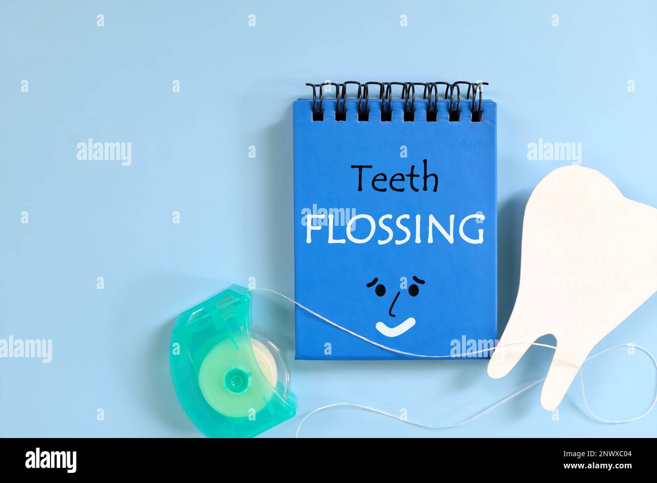 Teeth flossing guide on blue notepad. Dental and oral health care concept Stock Photo Alamy