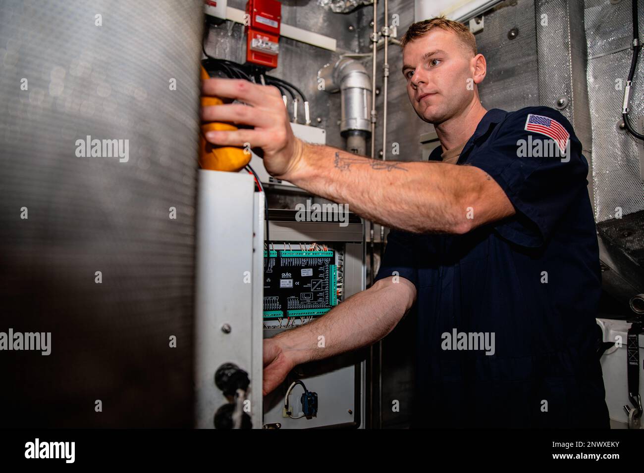 230206-A-NR779-1087 MANAMA, Bahrain (Feb. 6, 2023) U.S. Coast Guard Electrician’s Mate 2nd Class Ivan Markley inspects control panels aboard fast response cutter USCGC Glen Harris (WPC 1144), Feb. 6, while pierside in Manama, Bahrain. Glen Harris is deployed to the U.S. 5th Fleet area of operations to help ensure maritime security and stability in the Middle East region. Stock Photo