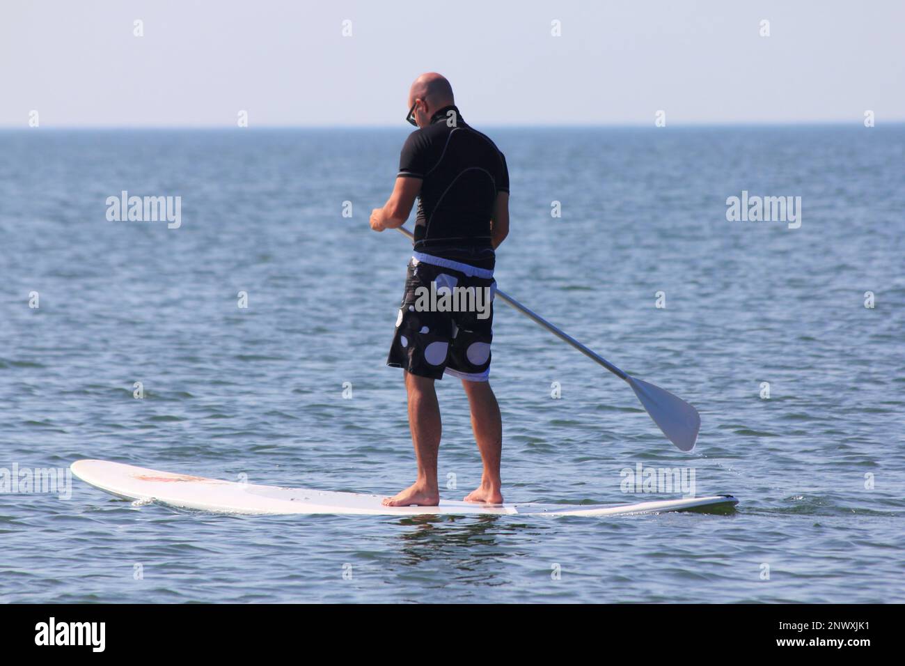 Brouwershaven, Netherlands August 22, 2015: Standing paddle on the North Sea coast at Brouwersdam Stock Photo