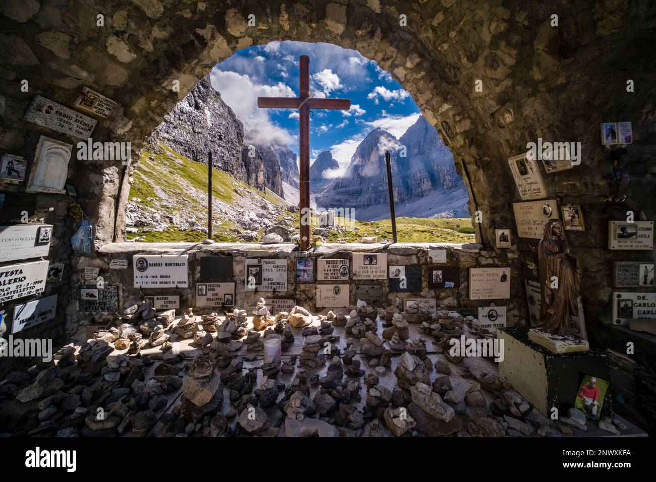 Inside the small chapel near the mountain hut Rifugio Maria e Alberto al Brentei in Brenta Dolomites, the mountain pass Bocca di Brenta in the distanc Stock Photo