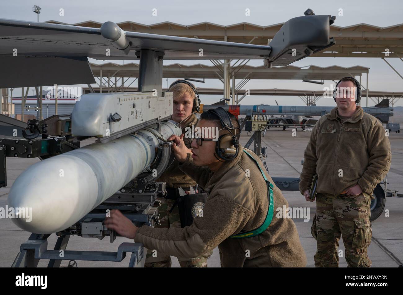 Airmen assigned to the 57th Aircraft Maintenance Squadron load a ...