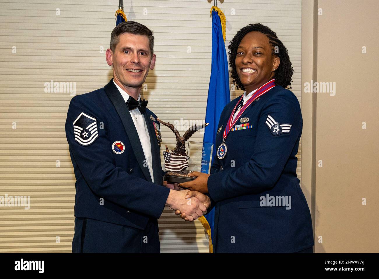 Senior Airman Shartavia Oaks, 4th Security Forces Squadron investigator, right, receives the commandant’s award from Master Sergeant Brandin Wendt, Airman Leadership School commandant, during ALS class 23-B graduation ceremony at Seymour Johnson Air Force Base, North Carolina, Feb. 9, 2023. The commandant’s award was given to the Airman in an ALS class that possesses the highest degree of character, competence and commitment. Stock Photo