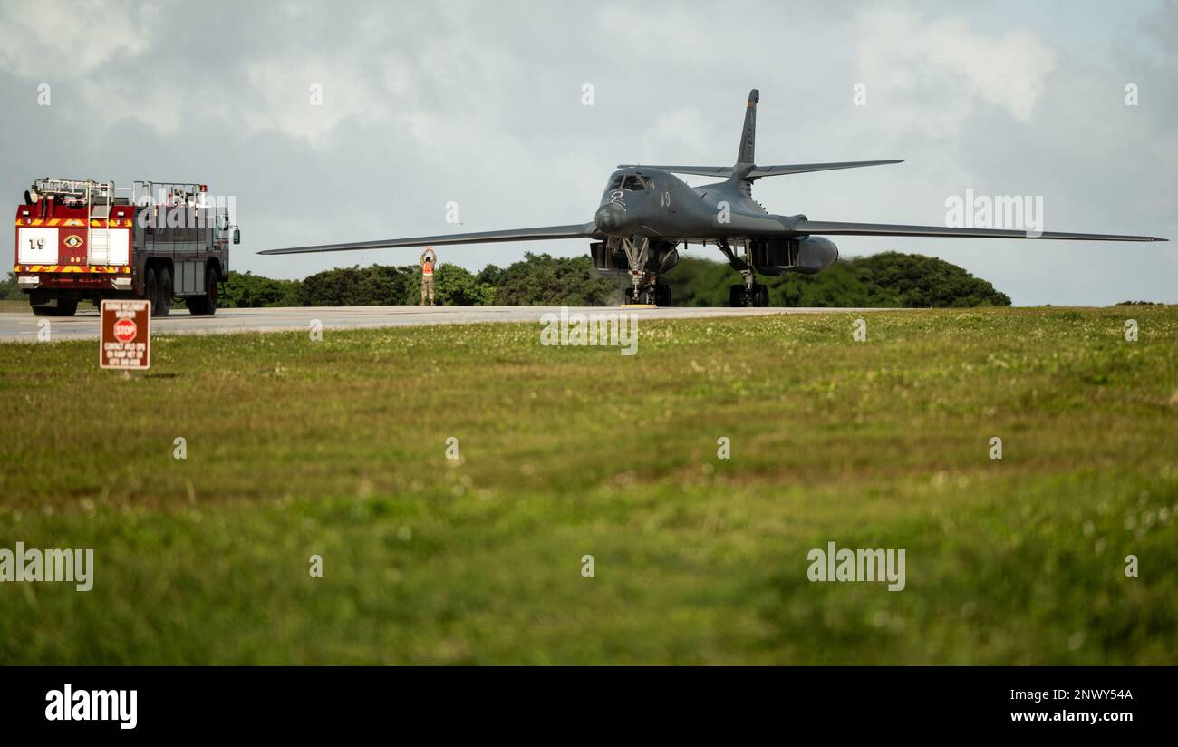 A U.S. Airman, assigned to the 34th Expeditionary Bomb Squadron, marshals a B-1B Lancer during a Bomber Task Force deployment at Andersen Air Force Base, Guam, Feb. 3, 2023. BTF missions demonstrate lethality and interoperability in support of a free and open Indo-Pacific. Stock Photo