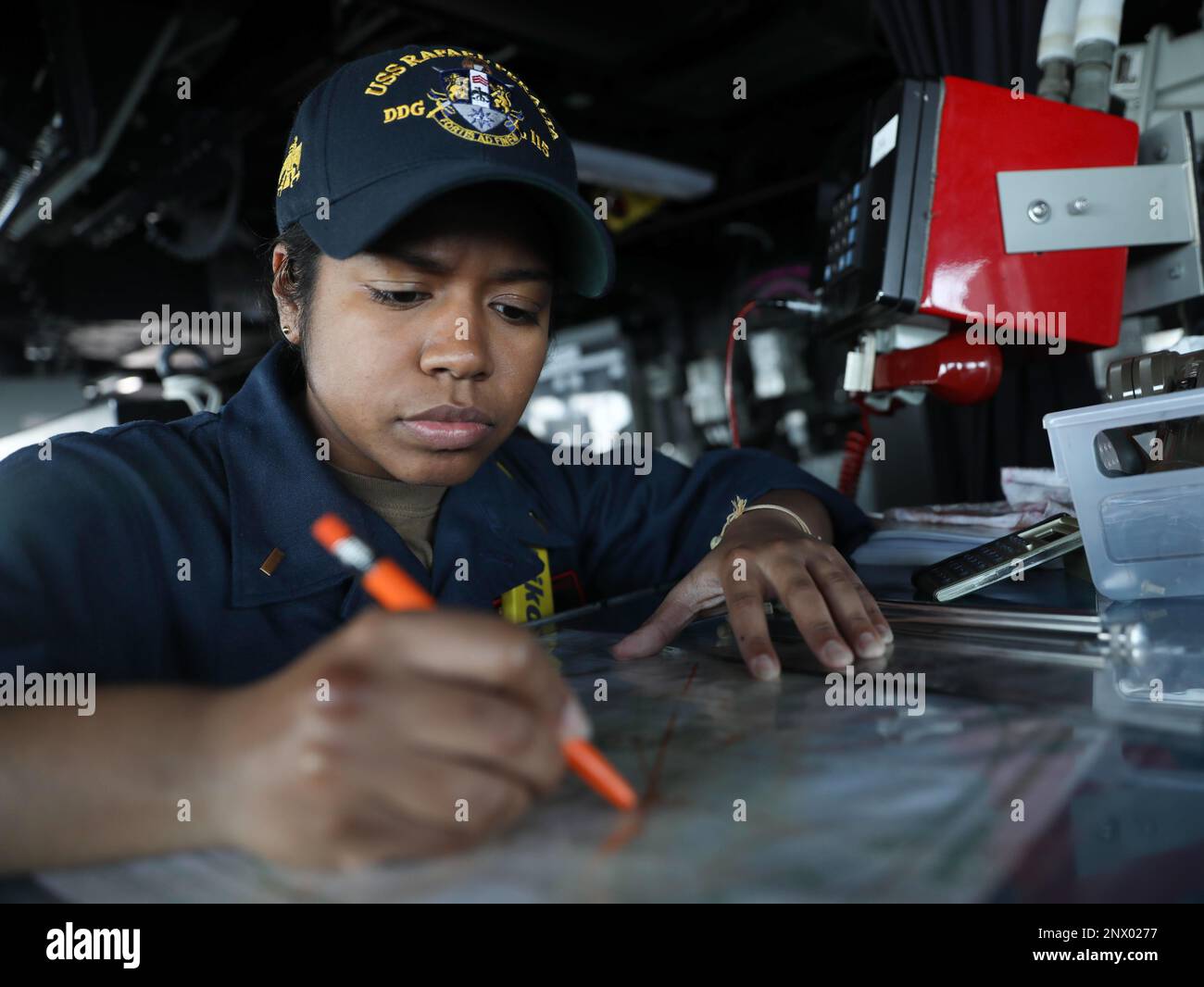 PHILIPPINE SEA (Jan. 23, 2023) – Ensign Lara Malaver, from White Plains, New York, develops a maneuvering solution on the bridge aboard the Arleigh Burke-class guided-missile destroyer USS Rafael Peralta (DDG 115) while operating in the Philippine Sea, Jan. 23. Rafael Peralta is assigned to Commander, Task Force 71/Destroyer Squadron (DESRON) 15, the Navy’s largest forward-deployed DESRON and the U.S. 7th Fleet’s principal surface force. Stock Photo