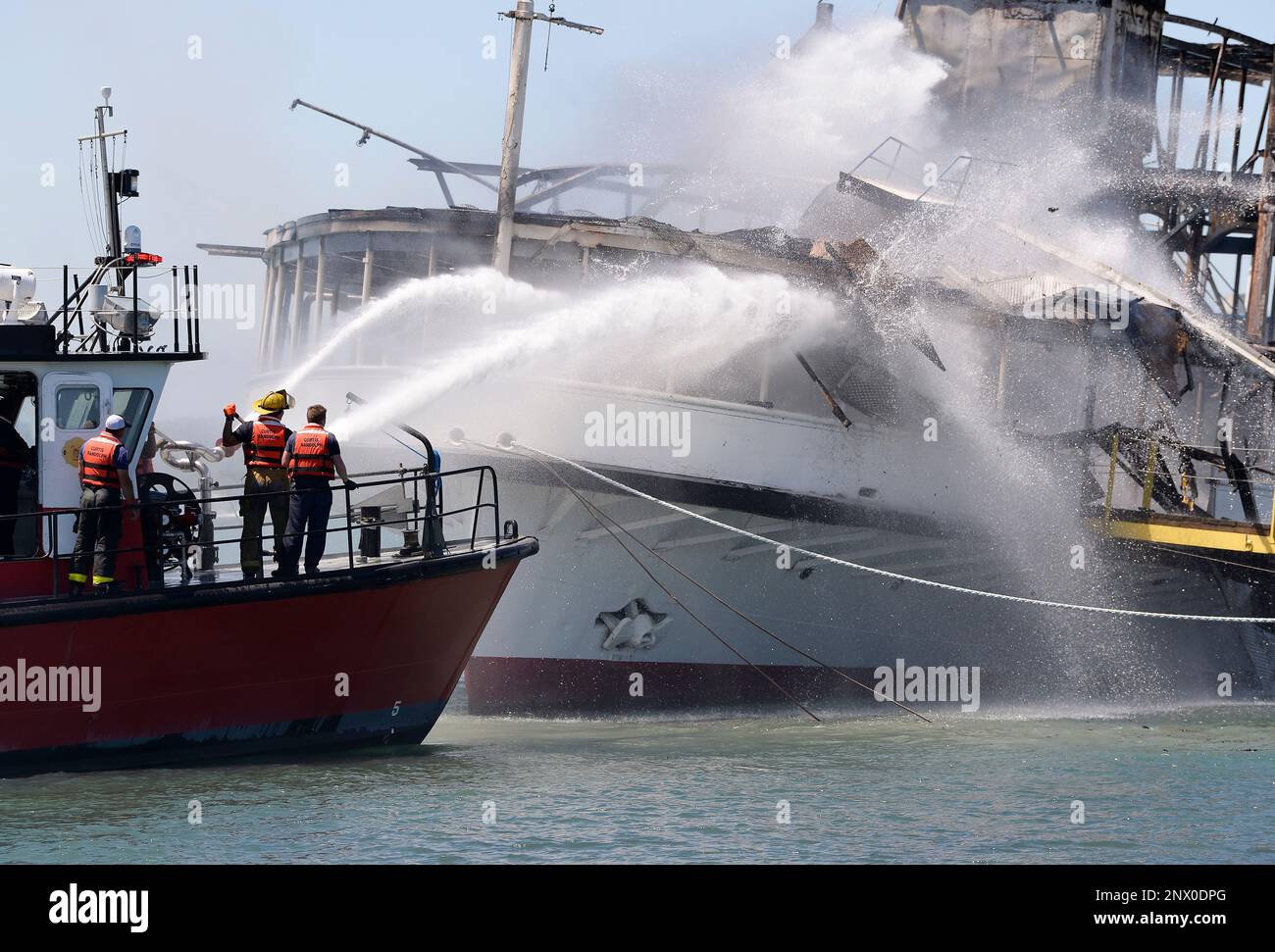 Members of the Detroit Fire Department Marine Corps spray water on the SS  Ste. Claire that was on fire at a marina in Detroit, on Friday, July, 6,  2018. The blaze on