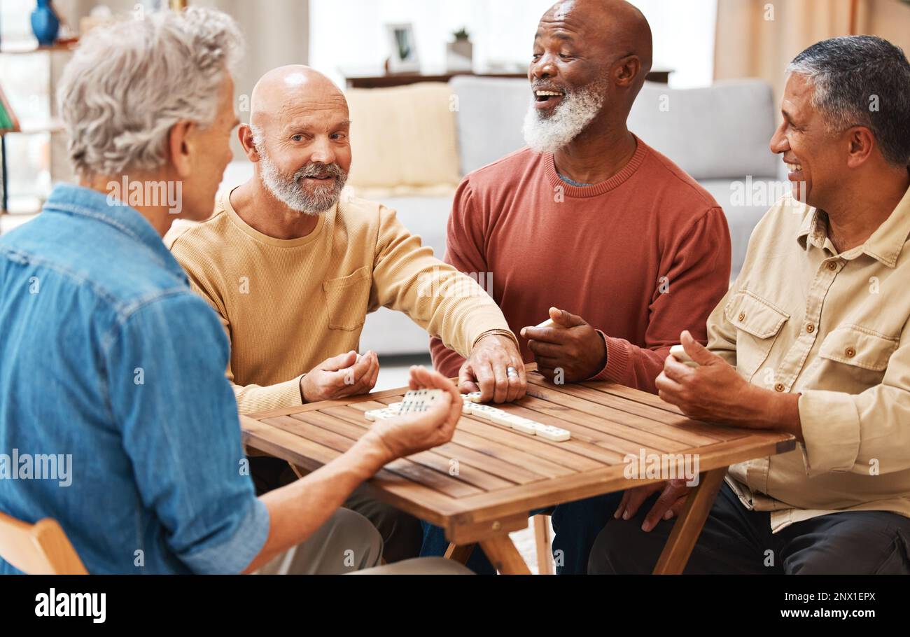 Senior men, friends and dominoes in board games on wooden table for  activity, social bonding or gathering. Elderly group of domino players  having fun Stock Photo - Alamy