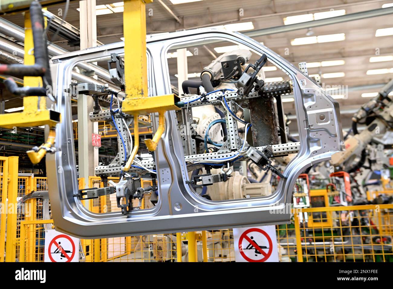 QINGDAO, CHINA FEBRUARY 1, 2023 A robot arm welds auto parts at a