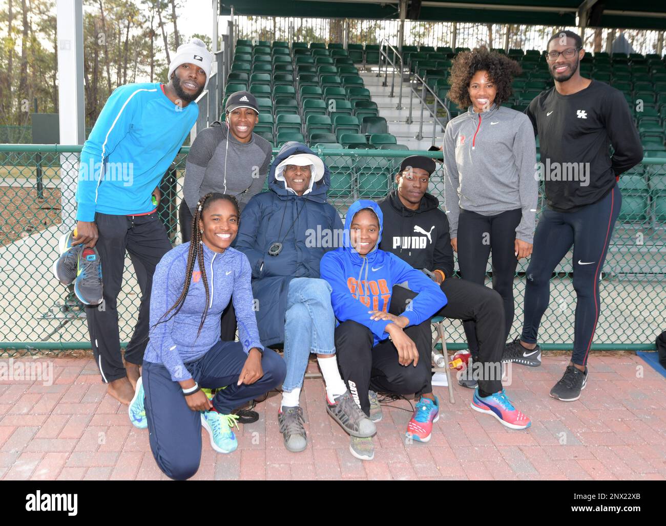 Athletes pose with coach Brooks Johnson during a workout in Kissimmee
