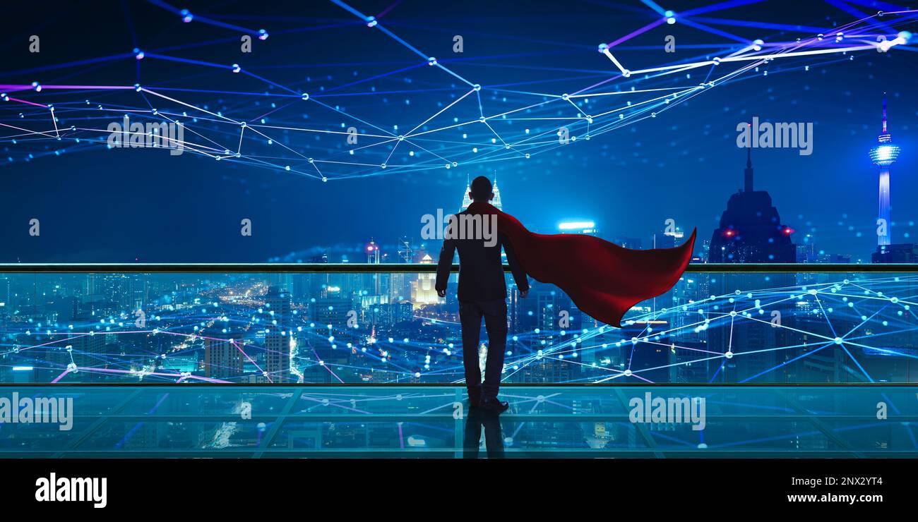 Hero Businessman standing at rooftop with Smart night city view. Business vision with smart big data technology concept Stock Photo