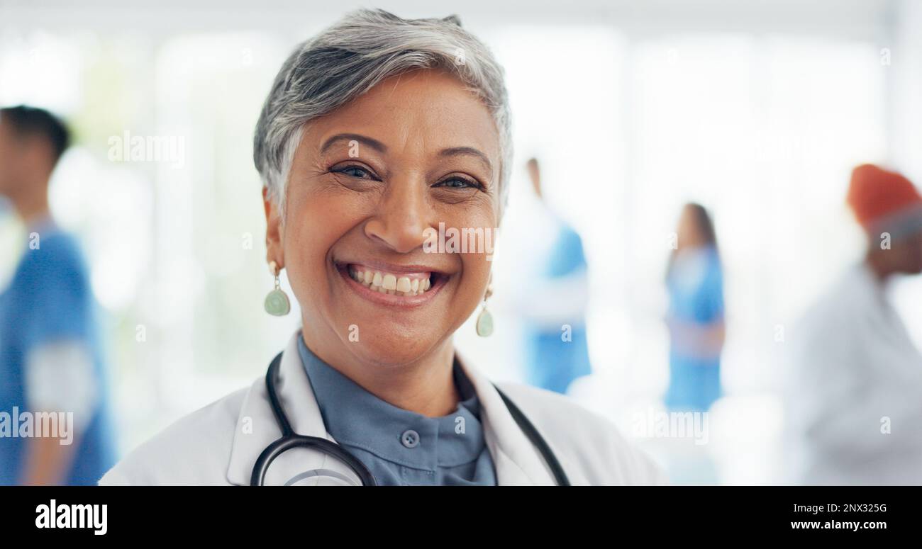Face, doctor and woman laughing in hospital ready for tasks, goals or targets. Leadership, senior or portrait of comic healthcare worker or female Stock Photo