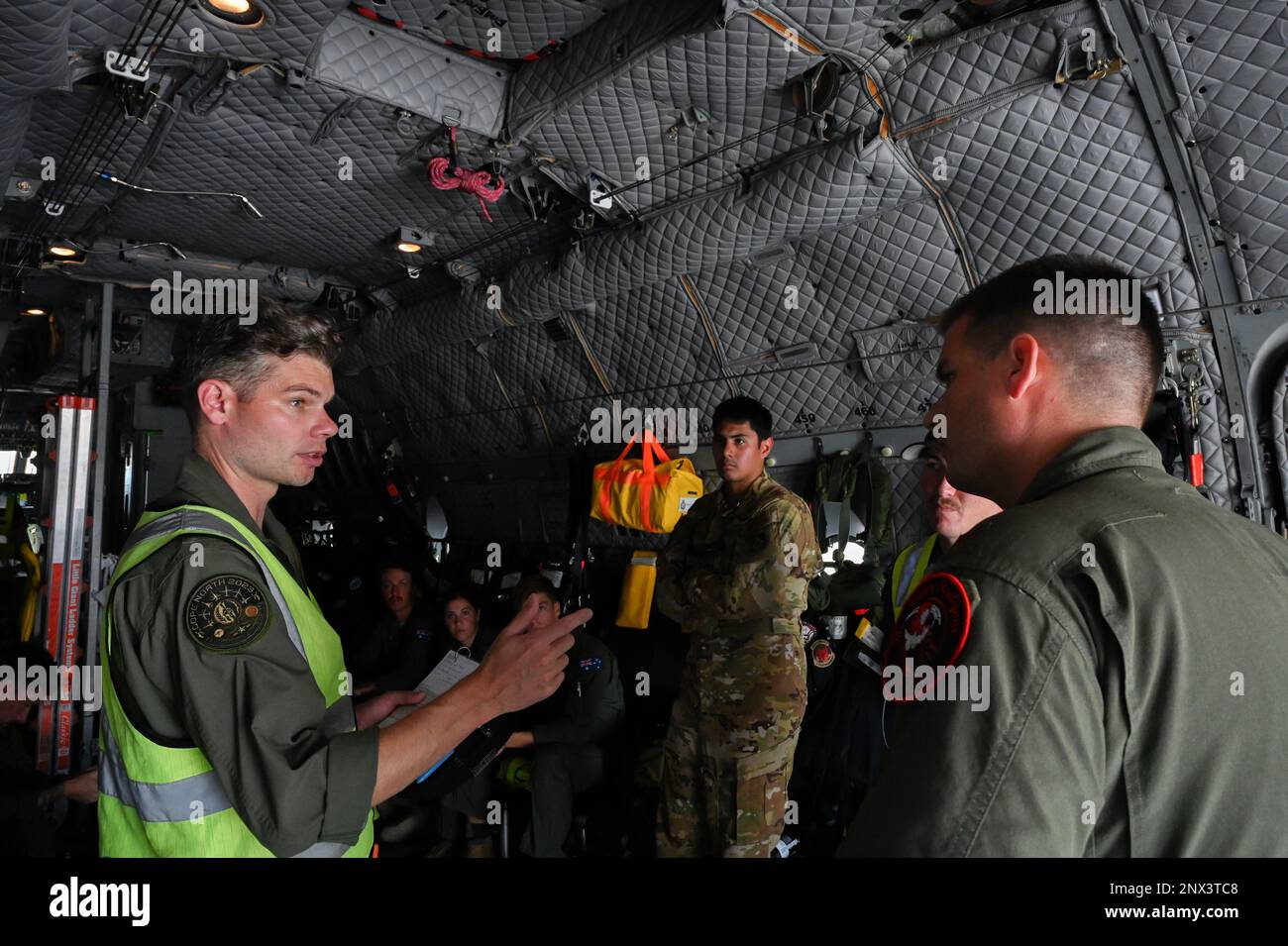 Royal Australian Air Force C-27J Spartan Aircraft Flight Lieutenant Ben Calaman, briefs a Search and Rescue mission with a U.S. Air Force member of the 119th Operations Groupon board C-27 prior to conducting a joint Search and Rescue mission supporting the U.S. Coast Guard that took place near Andersen Air Force Base, Guam on February 12 2023. These assets were able to support search and rescue operations due to being involved in Cope North, which is a combined forces exercise that focuses on building partnerships between the RAAF, U.S. Air Force, and Japan Air Self Defense Forces to enable a Stock Photo