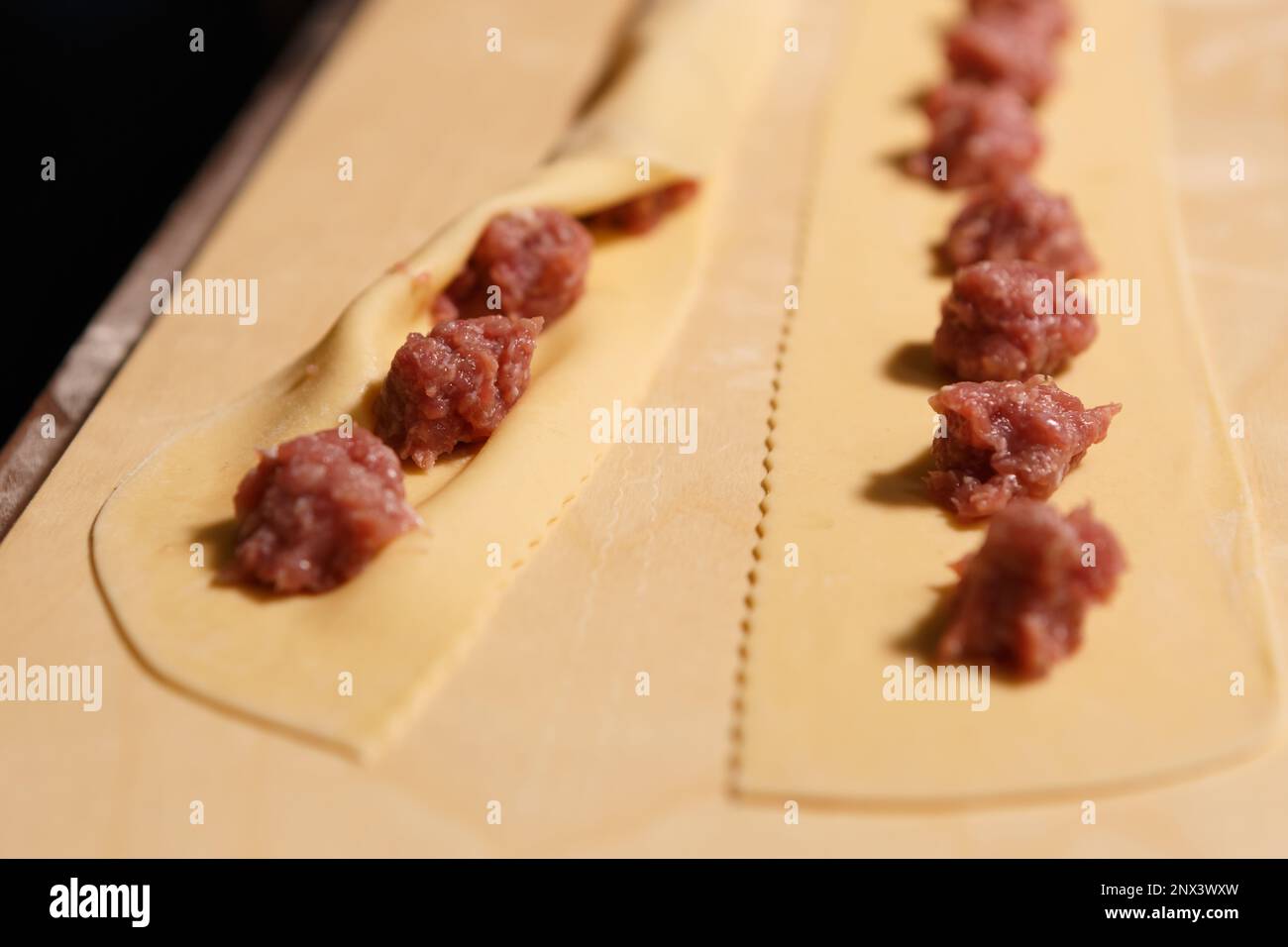 Process of cooking ravioli with red minced beef in Italian kitchen. Close up photo of dumpligns being cooked for dinner Stock Photo