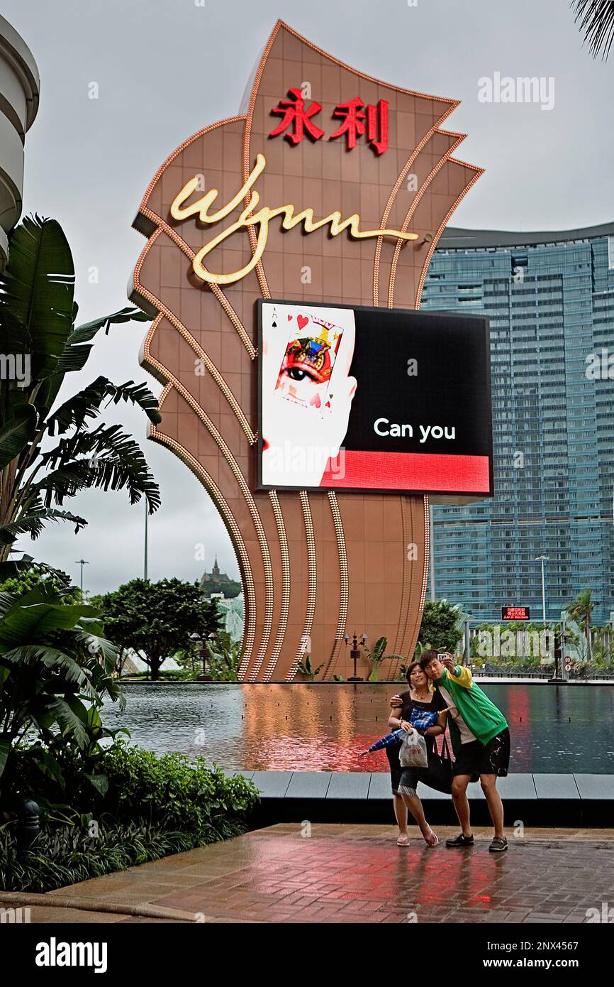 Couple taking picture in Main entry to Wynn hotel & casino,Macau,China Stock Photo