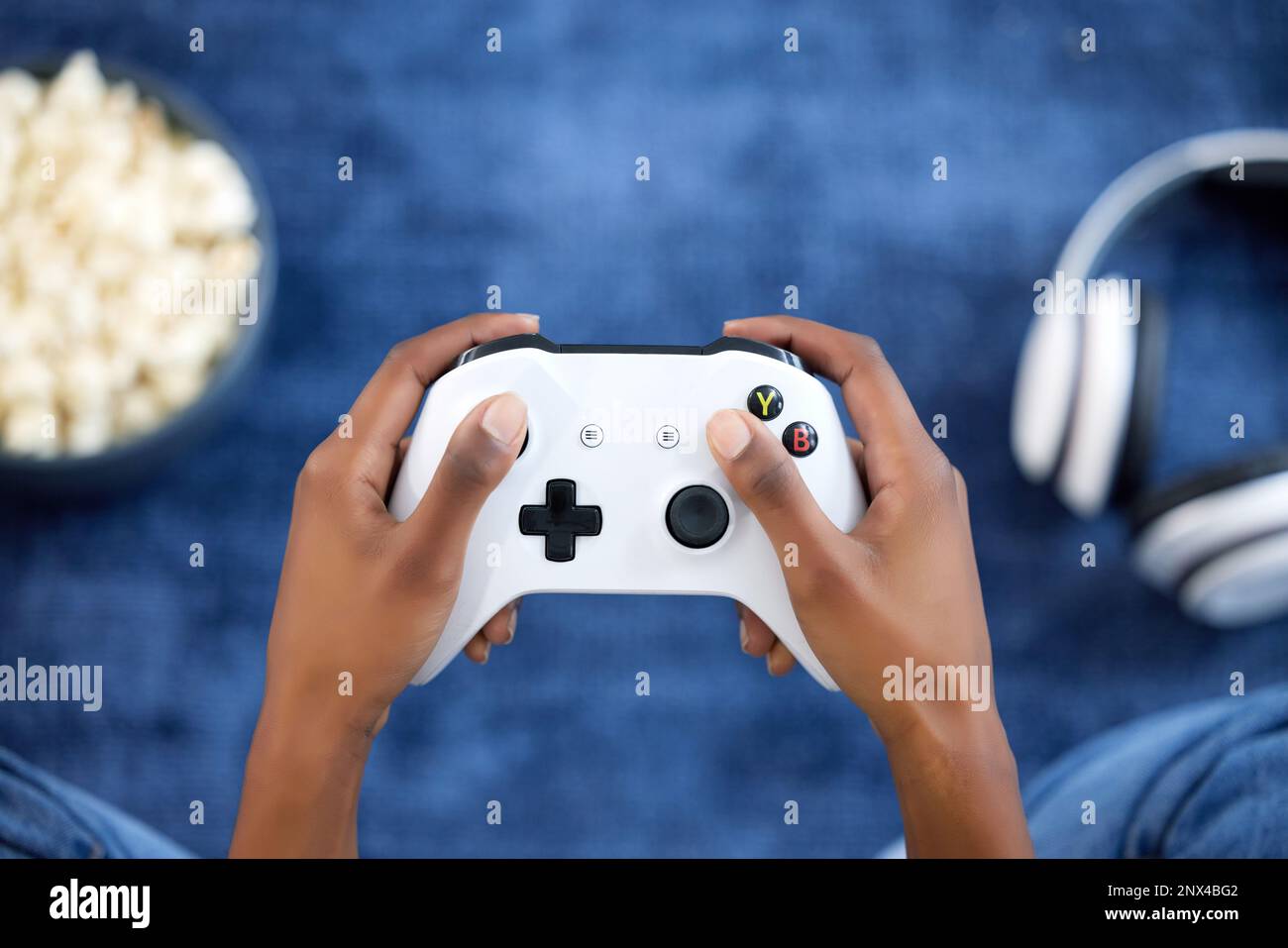 Hands, video games and person playing online game on home with popcorn for  gaming, gamepad and relax. Gamer woman console, joystick or control for  Stock Photo - Alamy