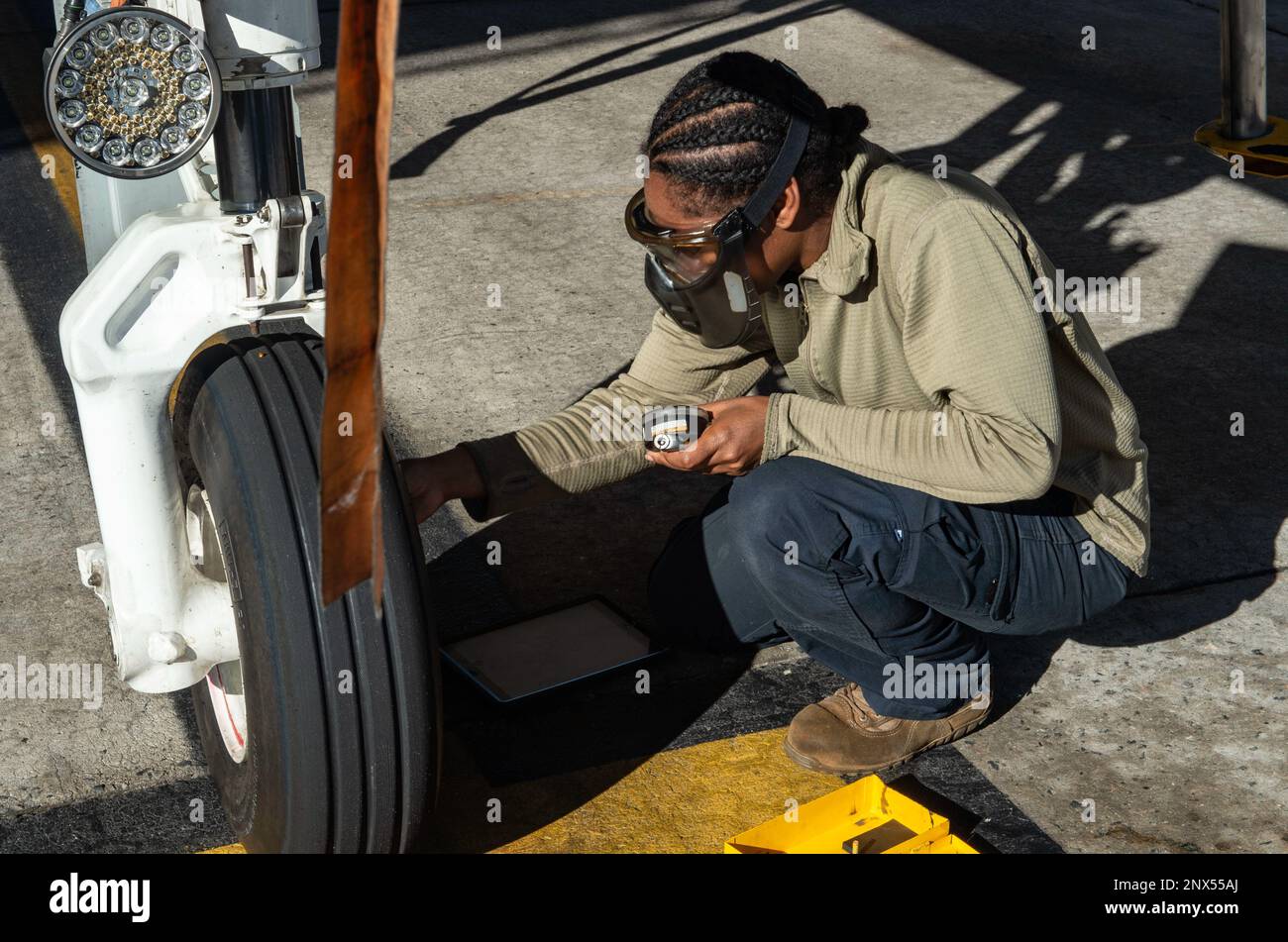 U.S. Air Force Staff Sgt. Jaymi White, 476th Maintenance Squadron crew chief, checks the nose tire pressure of an A-10C Thunderbolt II before a 476th Fighter Group unit training assembly exercise at Moody Air Force Base, Georgia, Jan. 6, 2023. Aircraft tire pressure checks must be completed no more than 72 hours prior to a flight. The A-10C’s nose tire pressure must range from 135-145 psi to ensure safe landing after a flight. Stock Photo