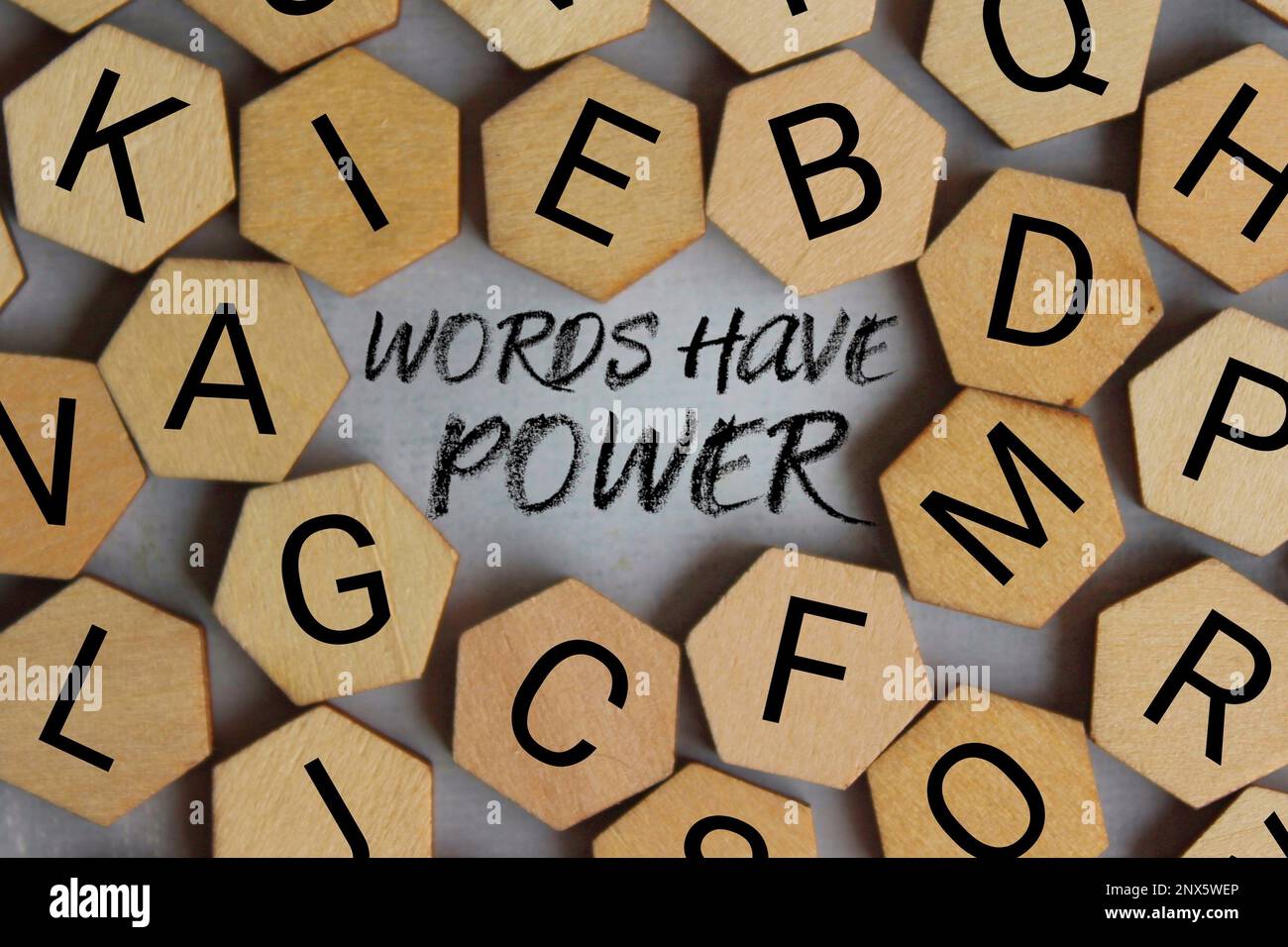 Top view image of wooden tiles with alphabets and text WORDS HAVE POWER Stock Photo