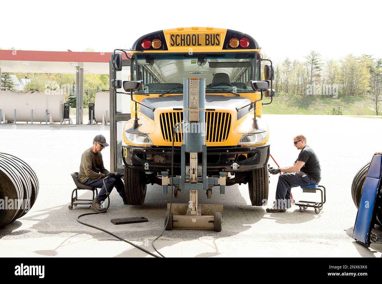 In this Thursday, May 16, 2018 photo, bus mechanics Rob Sawyer, left