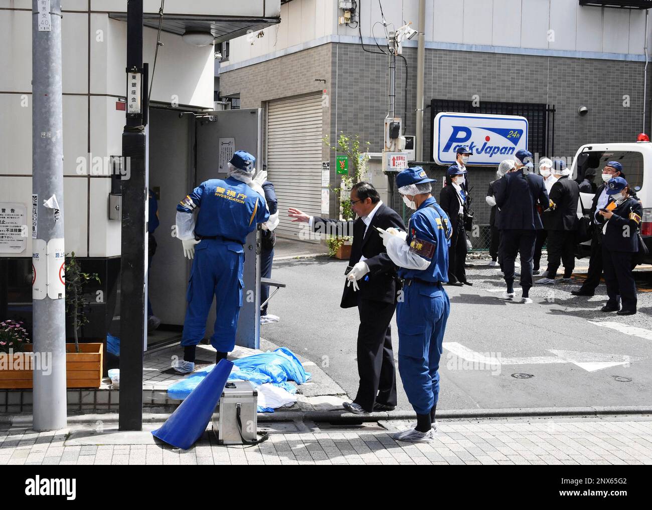 The Tokyo Metropolitan Police Department officers inspect the scene of ...