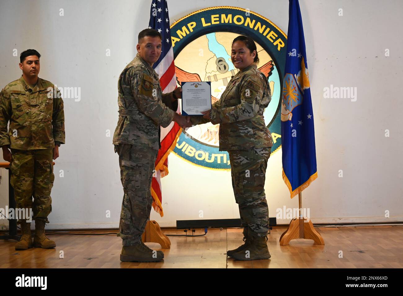 U.S. Air Force Col. Jason Chambers, commander of the 449th Air Expeditionary Group, awards Maj. Mercy Te’o, departing commander of the 726th Expeditionary Air Base Squadron (EABS), with the Meritorious Service Medal at the 726th EABS change of command ceremony at Camp Lemonnier, Djibouti, Feb. 1, 2023. The 726th EABS provides security forces, satellite communications, munitions support, vehicle management, contracting, finance and logistics in support of east Africa operations. Stock Photo