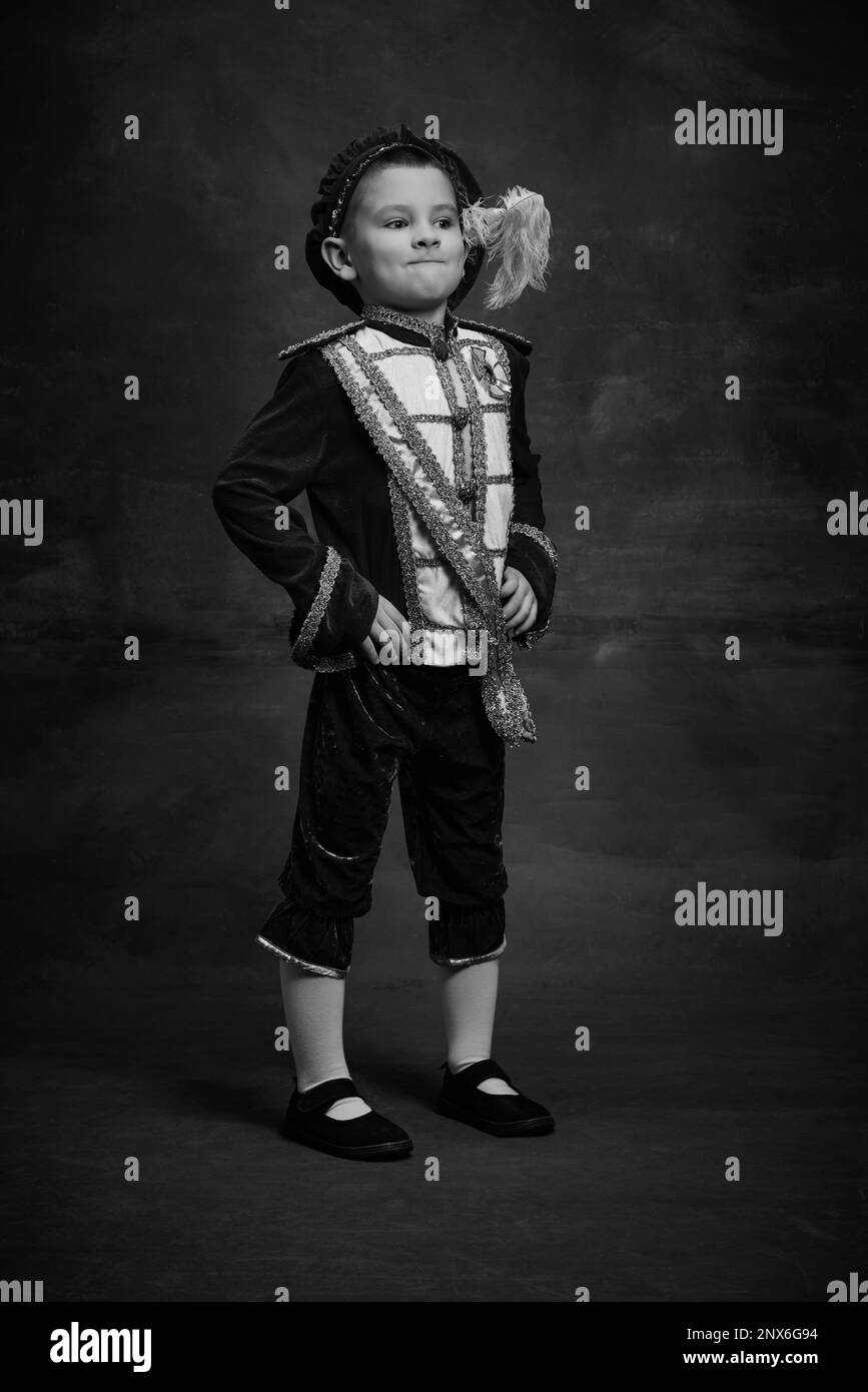 Black and white portrait of little boy dressed up as medieval character, little prince and