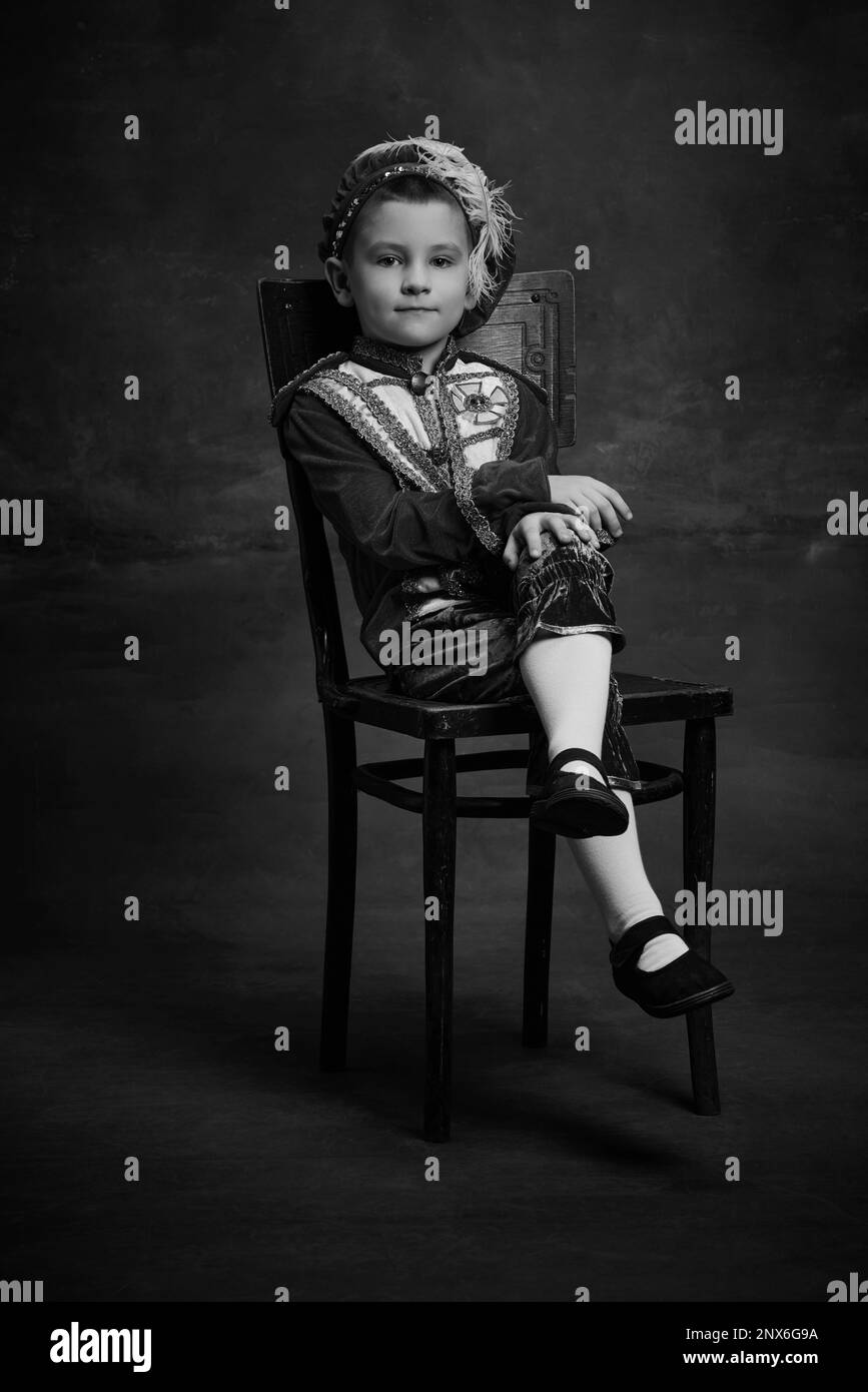 Black and white portrait of little boy dressed up as medieval character