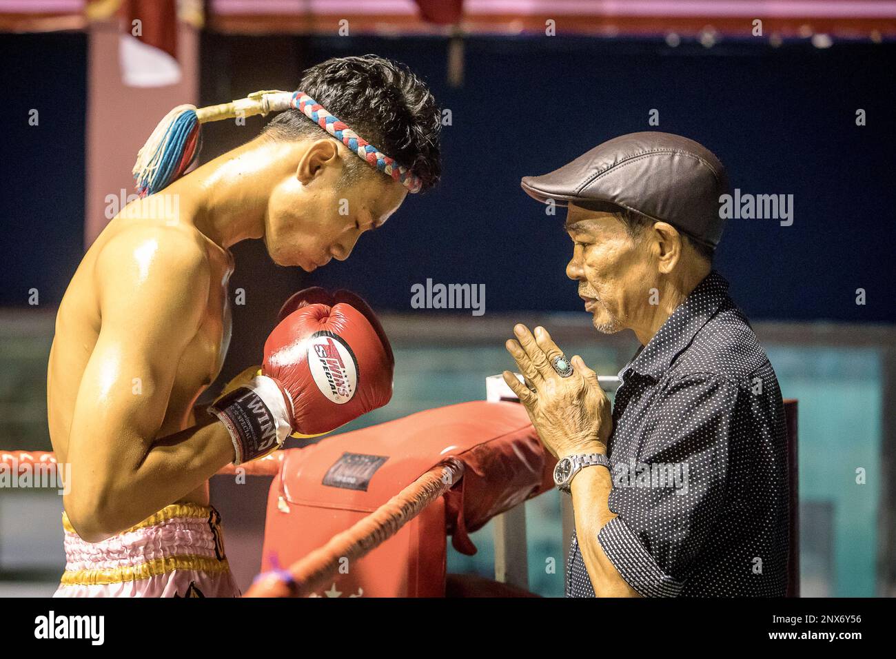 Coach and muay Thai fighter through pre-fight ritual, Bangkok, Thailand Stock Photo