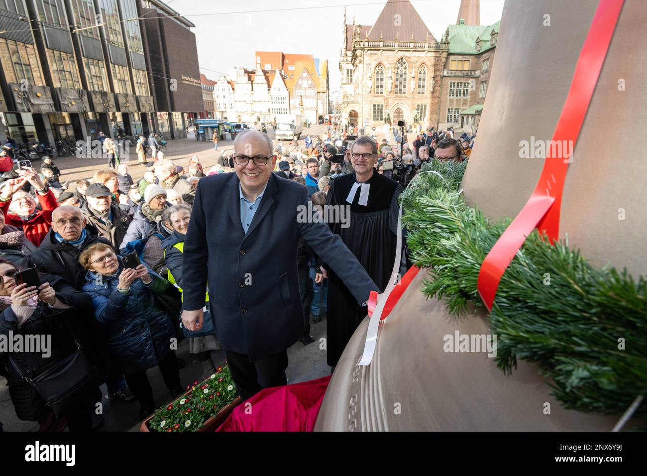 Bremen, Germany. 01st Mar, 2023. Andreas Bovenschulte (SPD), mayor of Bremen, stands next to the new 'Brema' bell at the cathedral portal. Bremen's St. Petri Cathedral is getting three new bells: the Peace Bell, the Justice Bell and the Creation Bell. Credit: Sina Schuldt/dpa/Alamy Live News Stock Photo