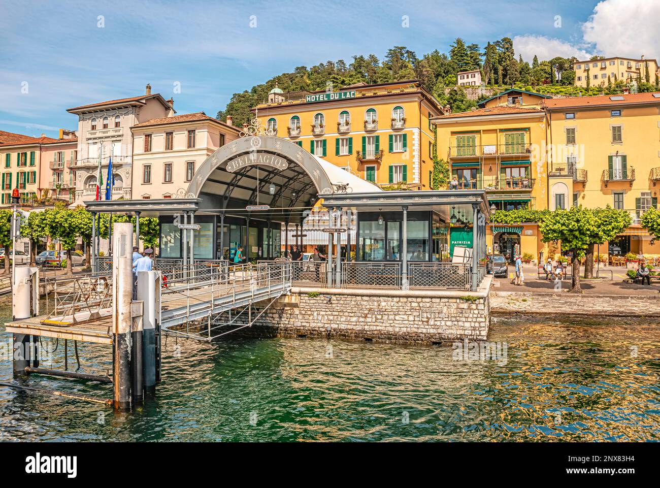 Shipping Pier of Bellagio at Lake Como seen from the lakeside, Lombardy, Italy | Schiffsanlegestelle an der Seepromenade von Bellagio am Lago di Como Stock Photo