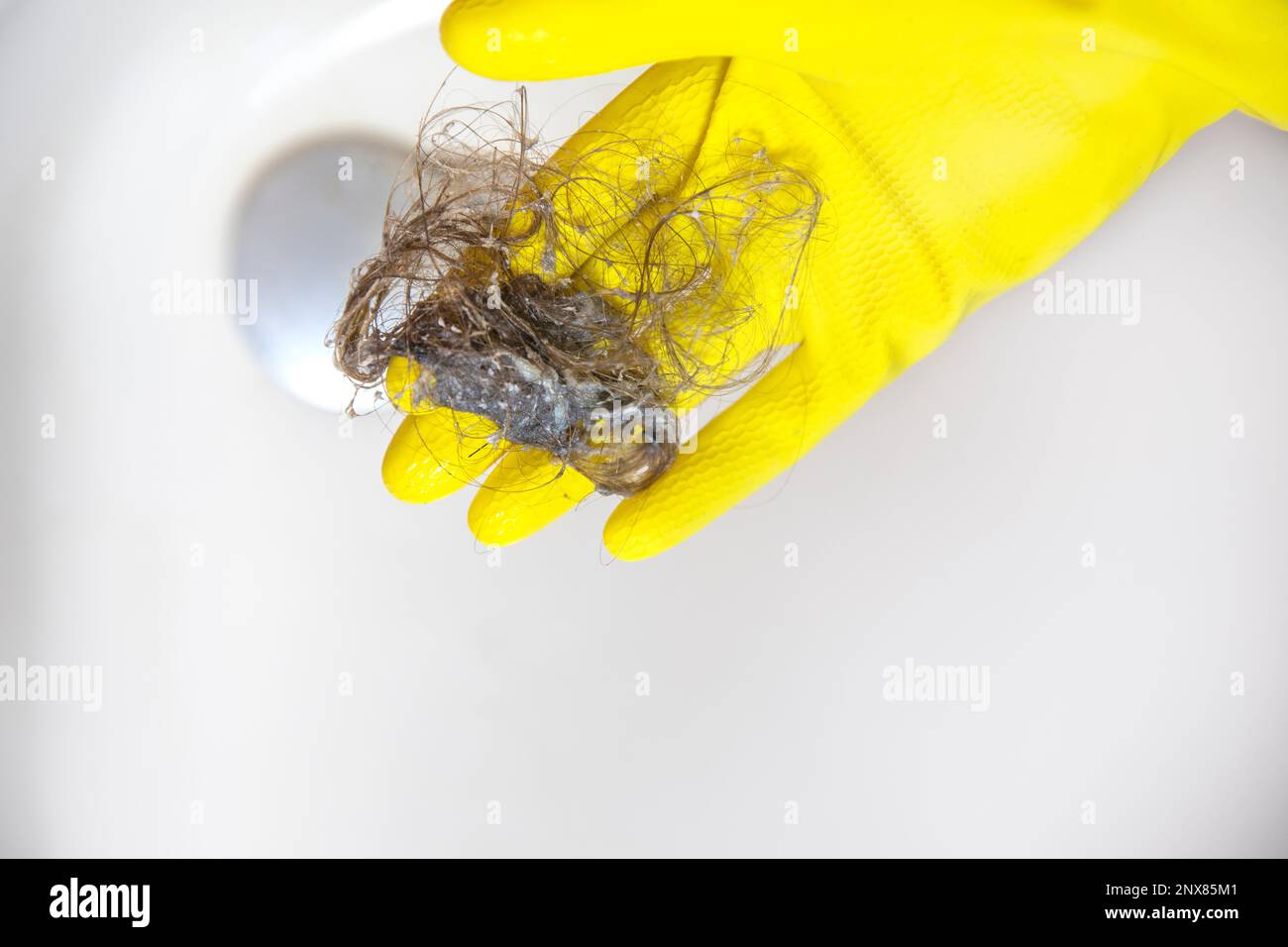 Shower drain is clogged with hair, Hair pile loss in a bathroom after