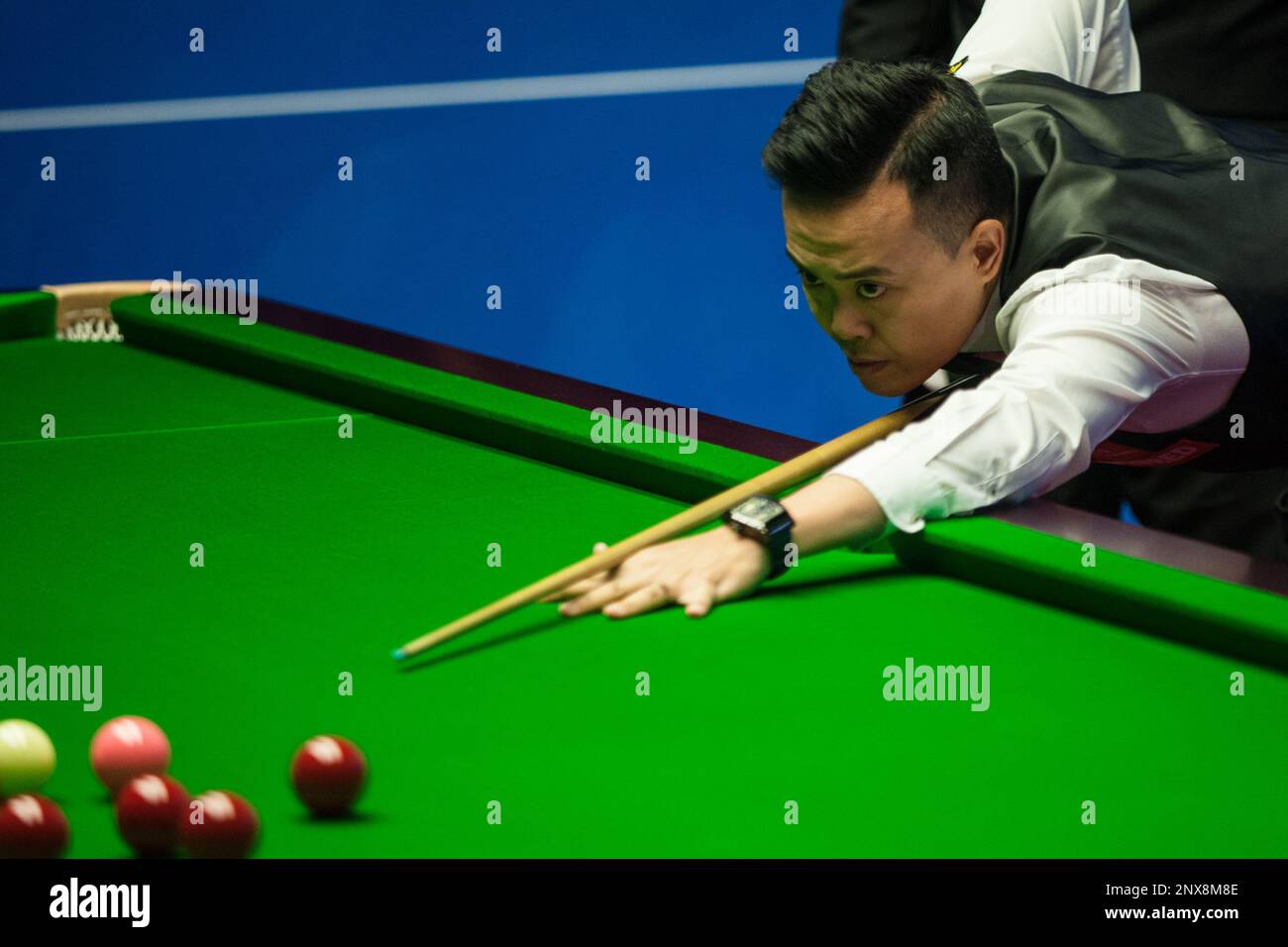 Marco Fu of Hong Kong plays a shot to Lyu Haotian of China in their first round match during the 2018 Betfred World Snooker Championship at the Crucible Theatre in Sheffield, UK,