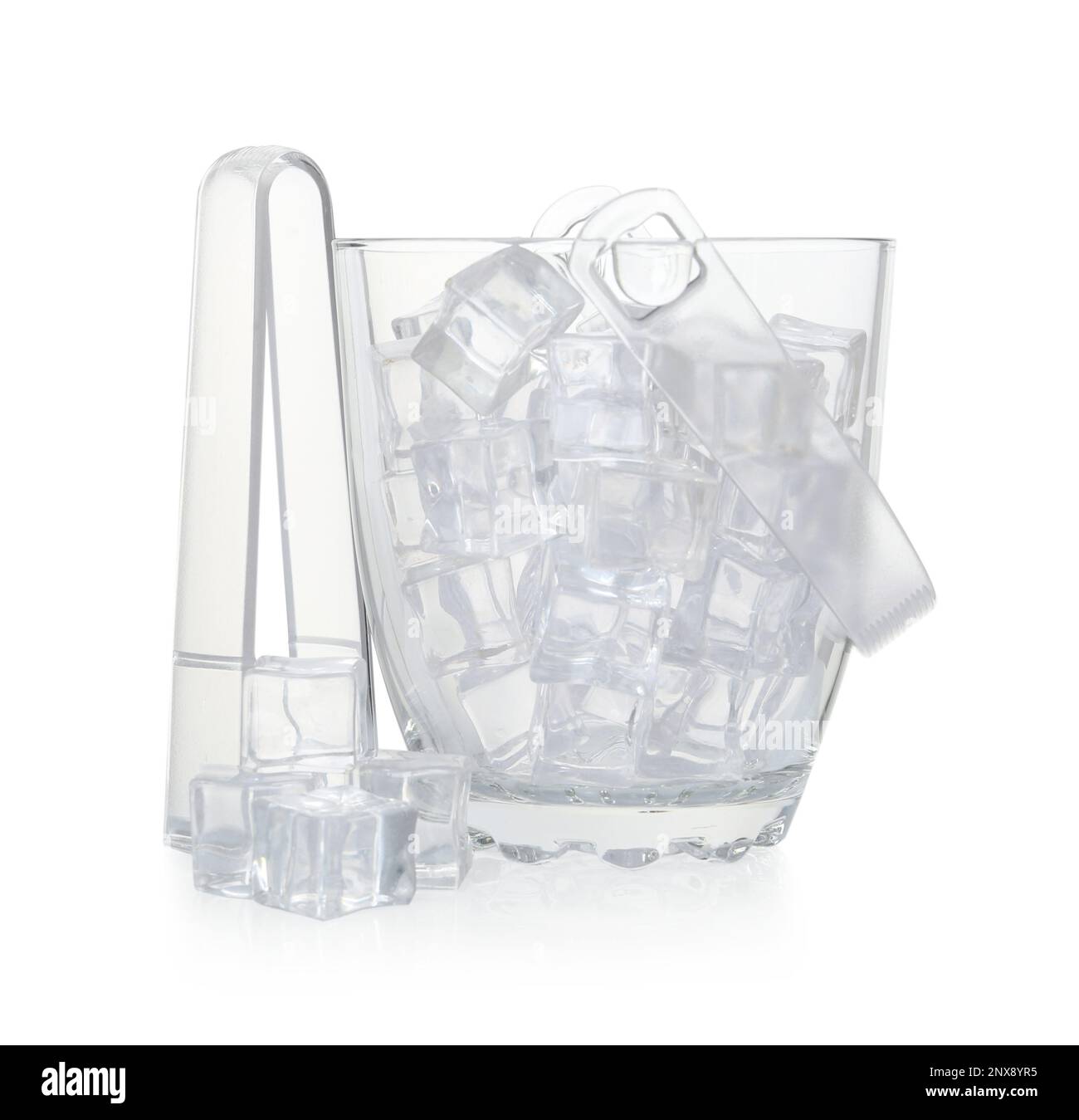 Glass bucket with ice cubes and tongs on white background Stock Photo