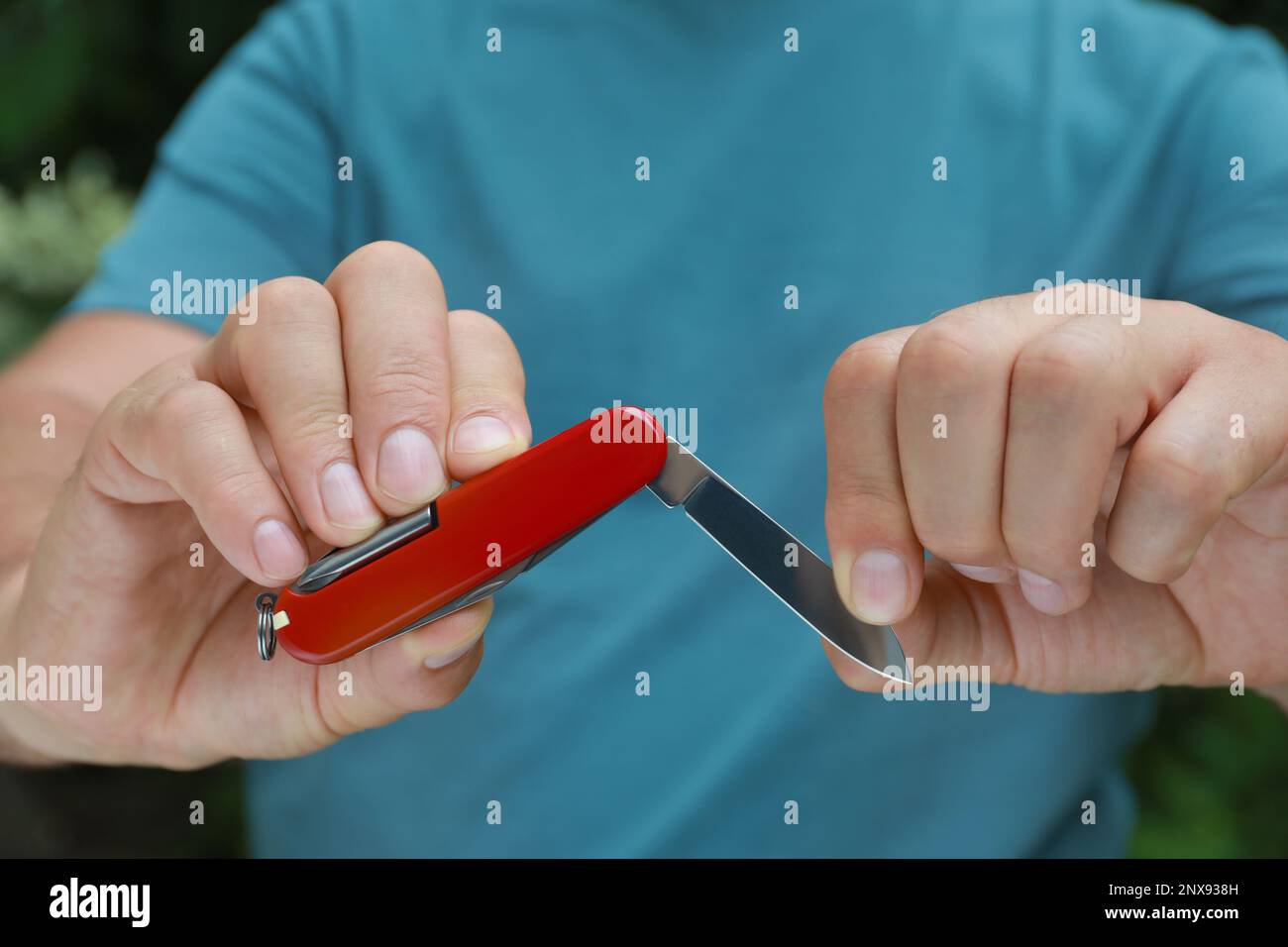 Man holding compact portable multitool, closeup view Stock Photo - Alamy