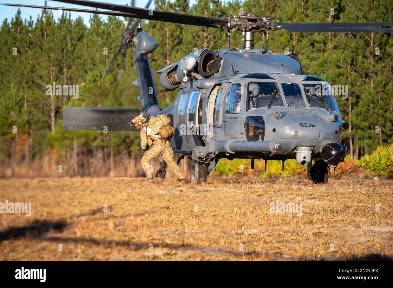 A Tactical Control Party Airman exits from the back of an HH60G Pave