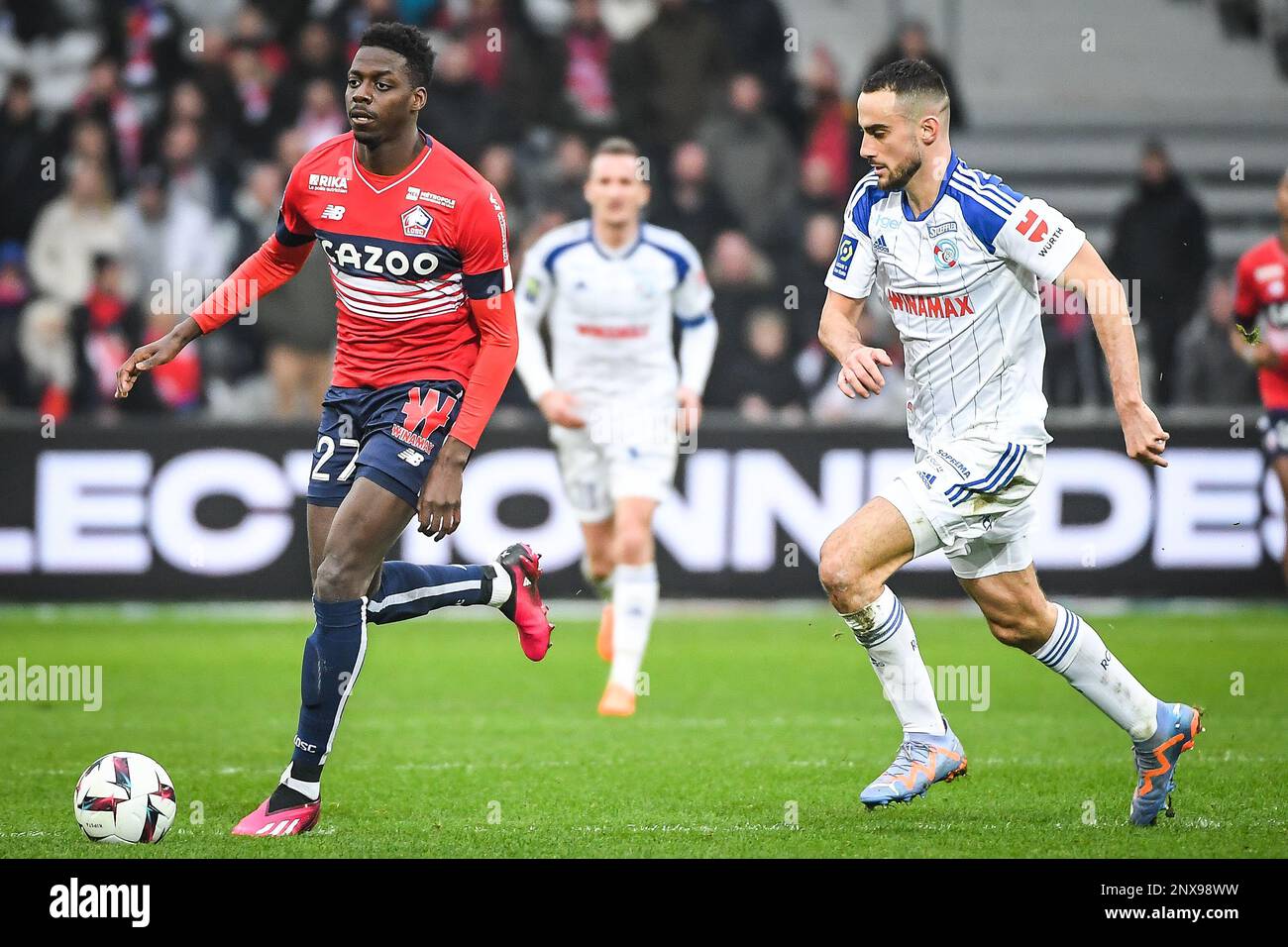 Mohamed BAYO of Lille and Lucas PERRIN of Strasbourg during the French championship Ligue 1 football match between Losc Lille and RC Strasbourg on February 12, 2023 at Pierre Mauroy stadium in Villeneuve-d'Ascq near Lille, France - Photo Matthieu Mirville / DPPI Stock Photo