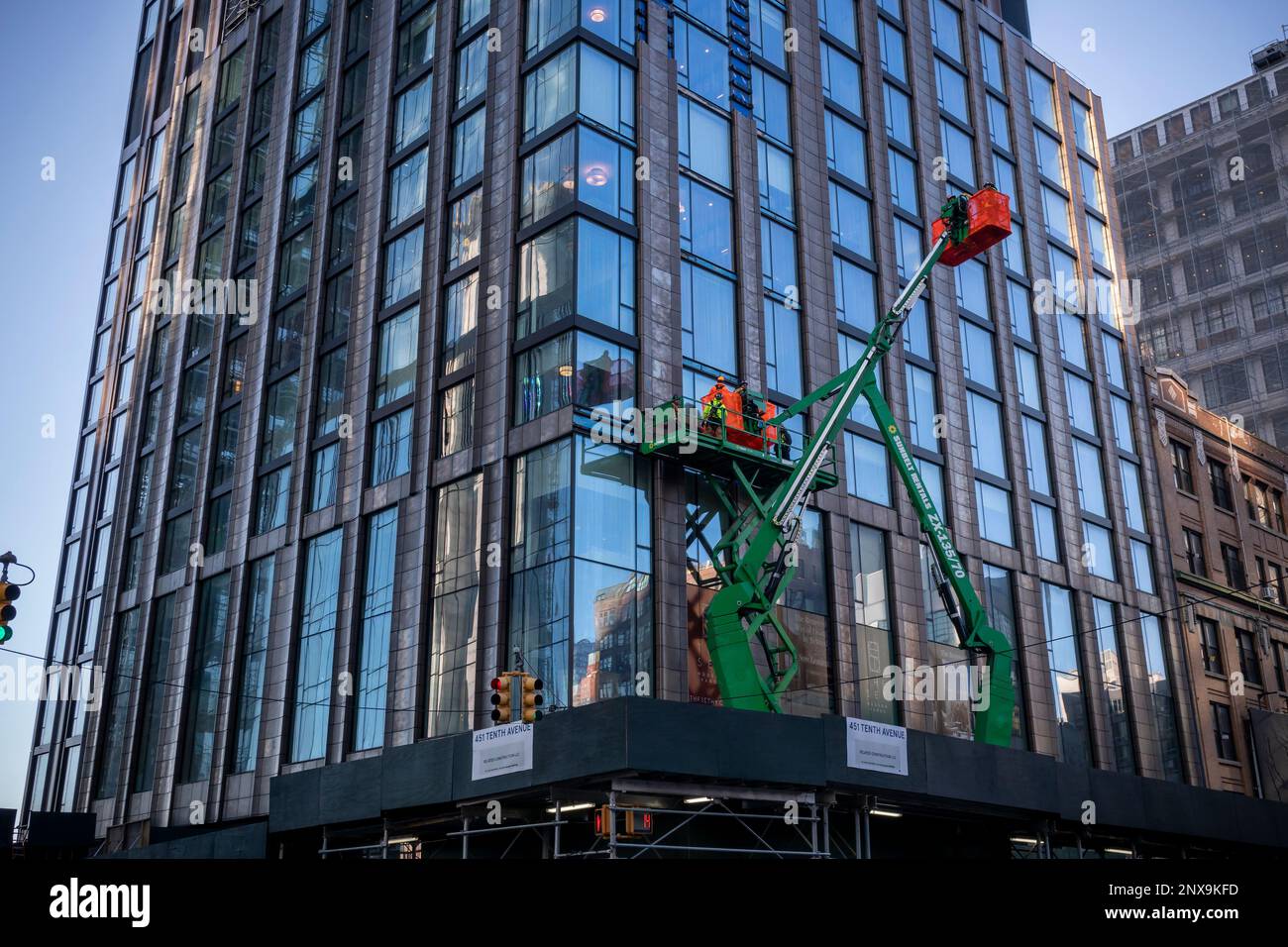 Construction work on a building at 451 Tenth Avenue in the Hudson Yards development area using snorkel lifts, seen on Tuesday, February 14, 2023 . (© Richard B. Levine) Stock Photo