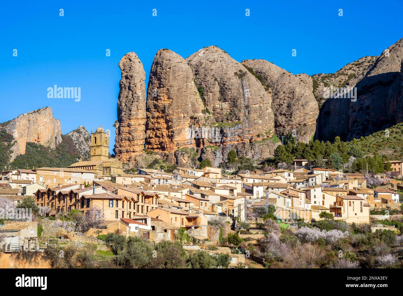 View of the village with the Mallos de Aguero rock formations behind, Aguero, Huesca, Aragon, Spain Stock Photo