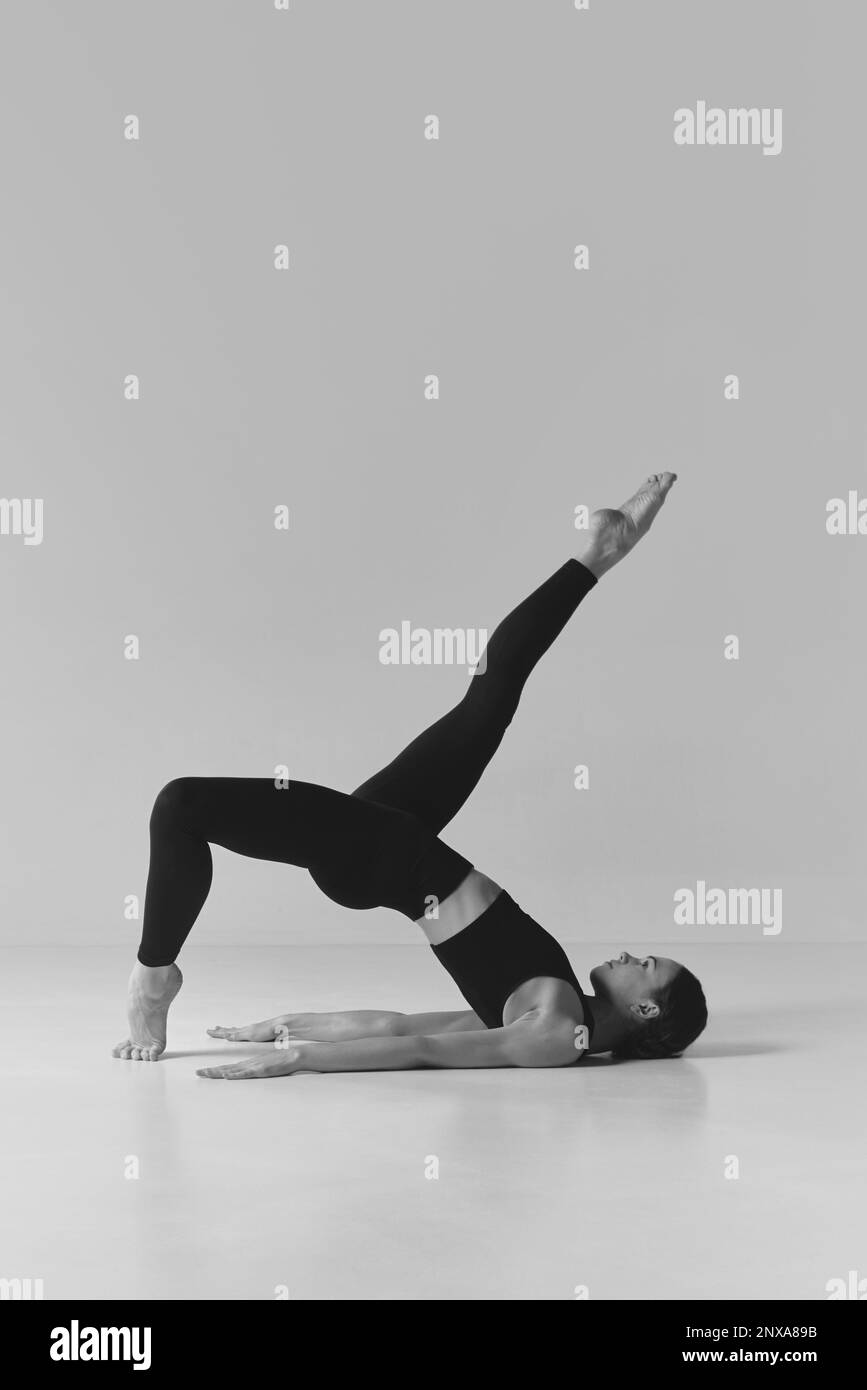 Black and white photography. Young girl with strong slim body doing