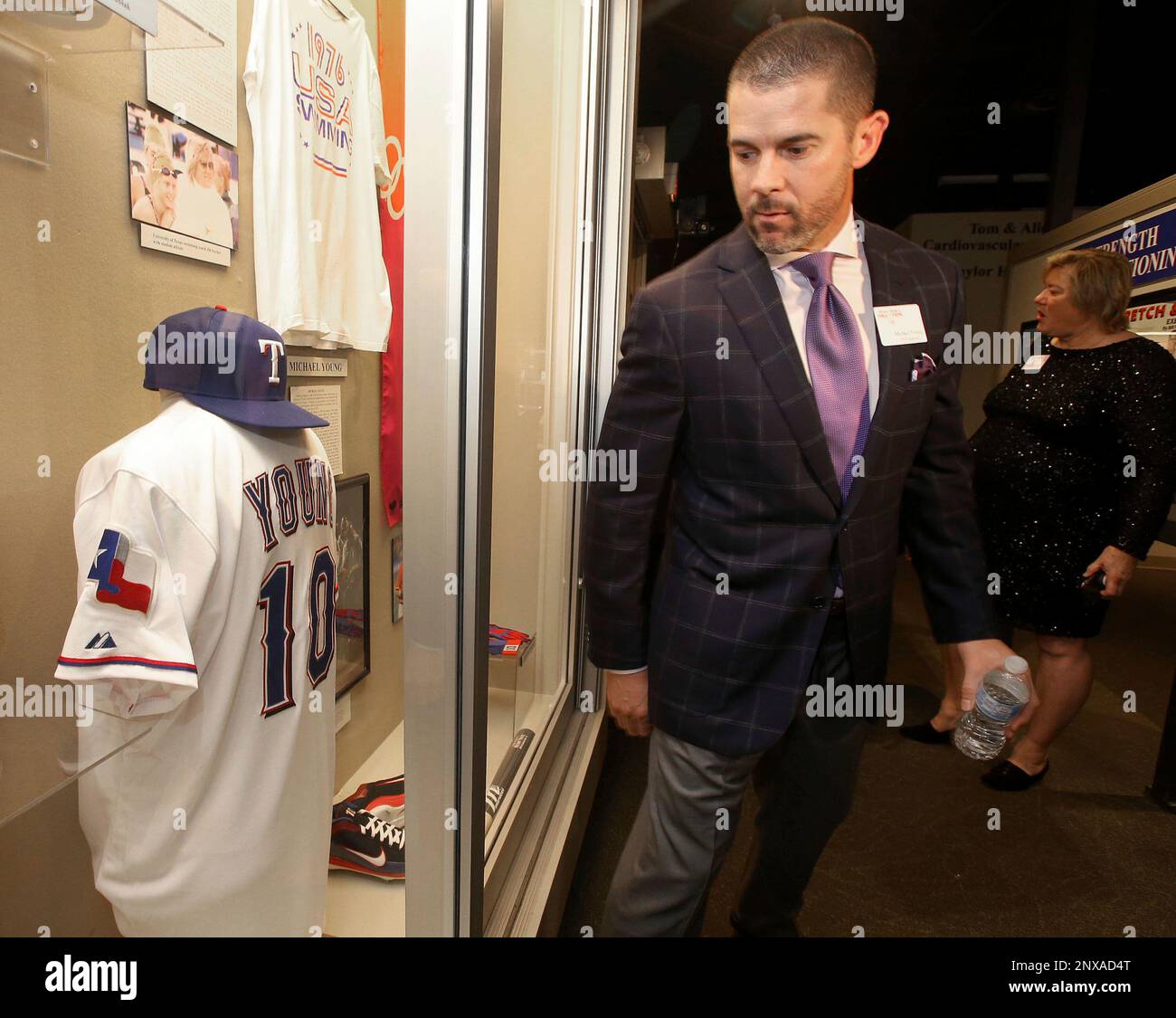 Former baseball player Michael Young looks over a display case with his  Texas Rangers jersey before being inducted into the Texas Sports Hall of  Fame, Saturday April, 7, 2018, in Waco, Texas. (
