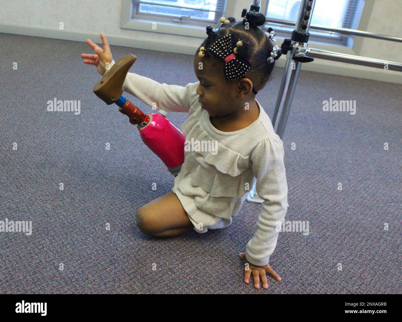 Heather Williams, of Gary, Ind., readjusts her prosthetic leg after