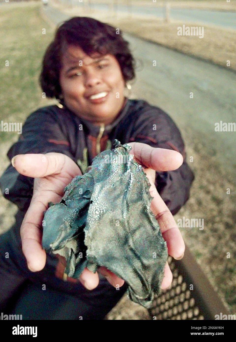 In a Jan. 1997 photo, Lottie Williams holds a piece of what is believed to  be part of a Delta II rocket which fell from the sky and hit her in the