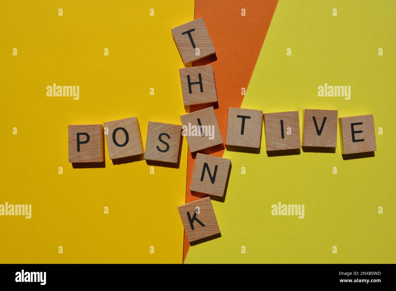 Think Positive, words in wooden alphabet letters isolated on background Stock Photo