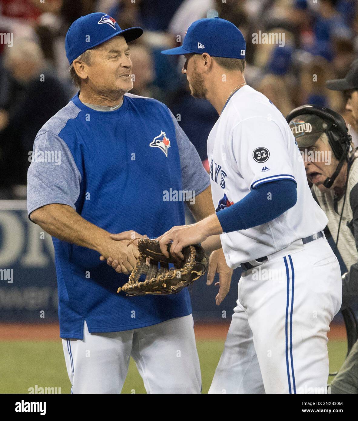 Toronto Blue Jays first baseman Justin Smoak, right, gets a handshake from  manager John Gibbons after they Blue Jays defeated the New York Yankees in  a baseball game in Toronto on Sunday