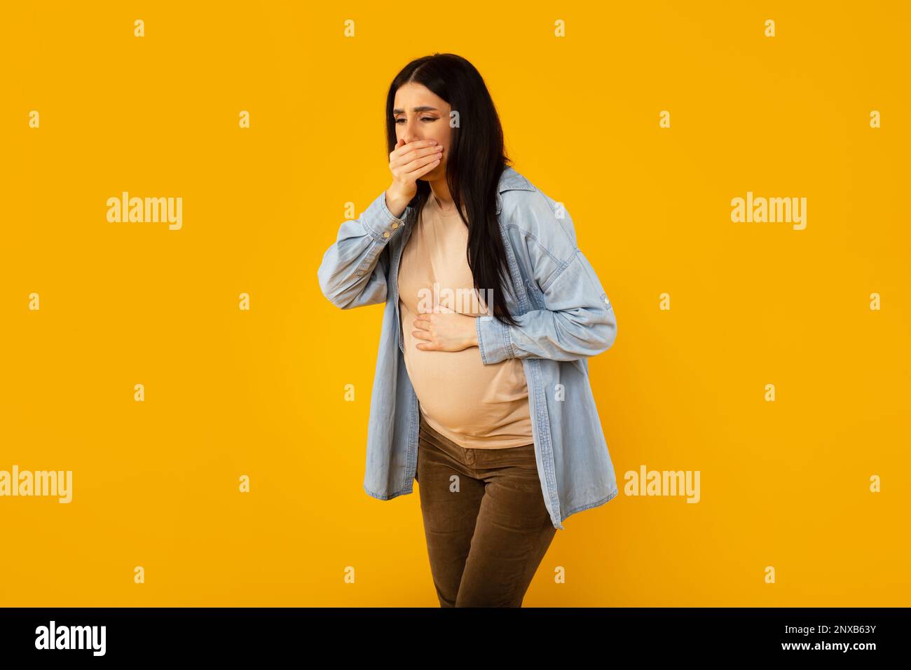 Pregnancy morning sickness. Young pregnant woman suffering from nausea